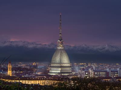 The Mole Antonelliana, home of the National Cinema Museum, over Turin at dusk