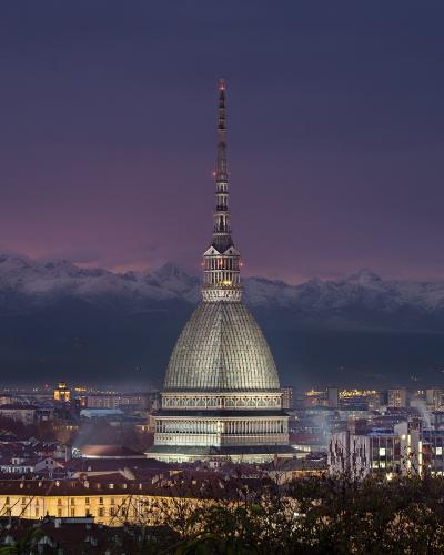 The Mole Antonelliana, home of the National Cinema Museum, over Turin at dusk