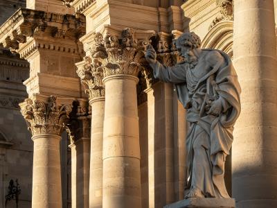 The statue of St. Paul before the columns of Siracusa Cathedral