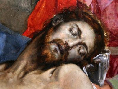 A close-up detail of a Renaissance oil painting depicting the dead body of Christ (Lamentation/Compianto) with a halo, red drapery, and a blue garment, showing visible craquelure and paint texture.