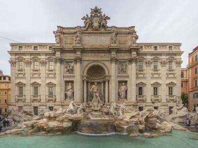 The image shows the Trevi Fountain in Rome, Italy, featuring its grand Baroque architecture with statues of Oceanus, allegorical figures, and cascading water into a large basin, surrounded by tourists and adjacent buildings.