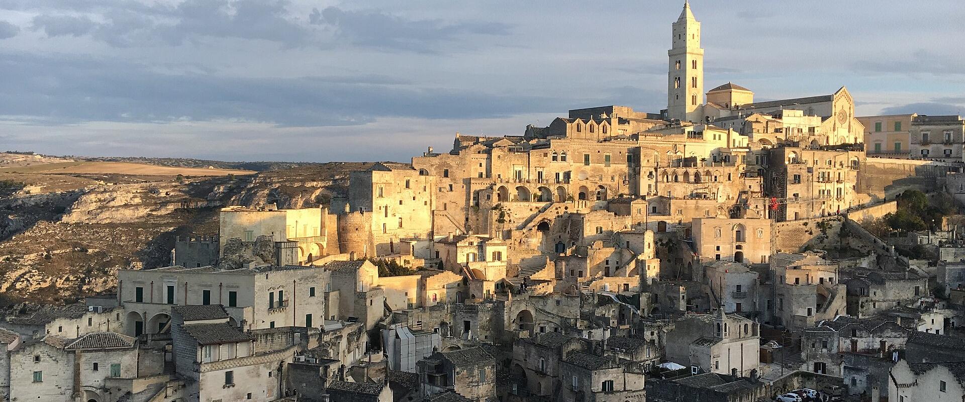 The Sassi di Matera and the cathedral bell tower in warm evening light