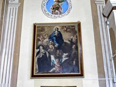 Interior wall of a church featuring a large framed painting of religious figures, a circular medallion with an image of Saint Blase (San Biagio) above it, and fluted pilasters.