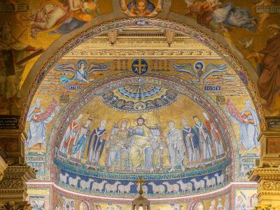 The image shows the interior apse mosaic of a church, featuring Christ enthroned with saints and angels, flanked by figures labeled "MATHEUS" and "IOHS," with Latin inscriptions and a golden background typical of Byzantine-style religious art.