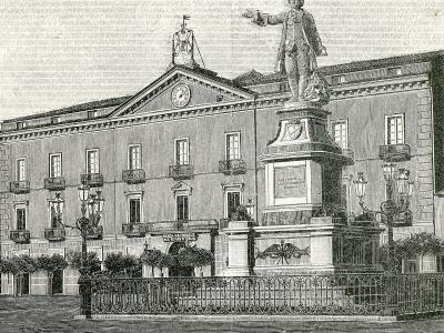 A black-and-white engraving showing a large public square with a prominent statue of Luigi Vanvitelli on a pedestal in the foreground and a grand neoclassical building behind it, identified by signage as "BANCA NAZIONALE DEL LAVORO" (National Bank