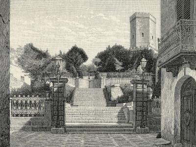 A 19th-century wood engraving depicting a stone staircase leading up to a fortified tower, flanked by trees and a building with a balcony on the right.