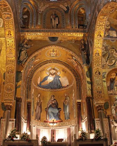 The image shows the interior of a highly ornate Byzantine-style chapel with extensive gold mosaics, including a central mosaic of Christ Pantocrator in the apse, flanked by saints and angels, with Latin inscriptions and distinctive spiral columns.