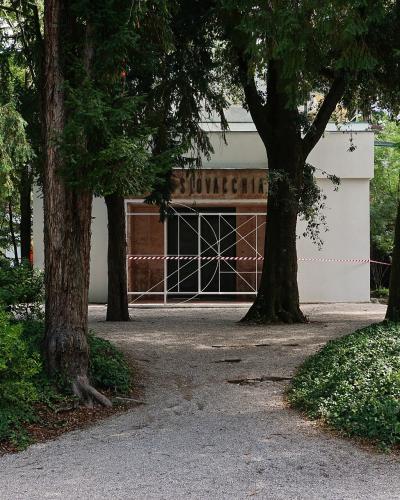 A tree-lined path to a pavilion in the Giardini della Biennale, Venice