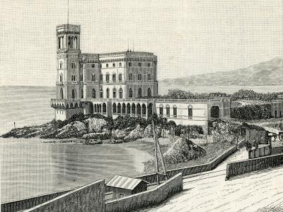 A vintage engraved illustration of a large, multi-story castle with a prominent square tower and arched windows, situated on a rocky promontory directly overlooking the sea, with a coastal road and small boat in the foreground.