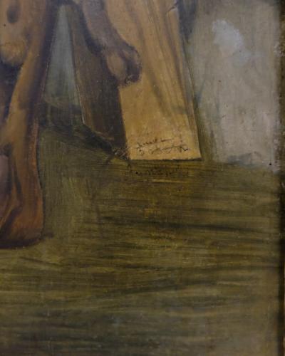 A close-up detail of a painted artwork showing a human foot and lower leg, with visible brushwork and a signature or inscription on a wooden element, framed by an ornate, gilded picture frame.