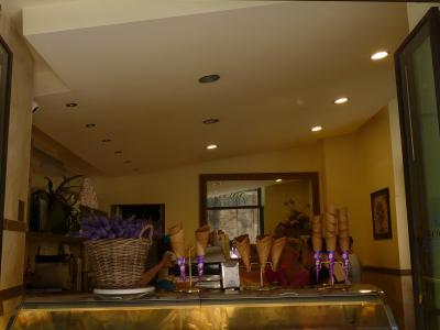 The image shows the storefront of "Brivido Gelateria," an ice cream shop with a display case of gelato, waffle cones, and interior lighting.