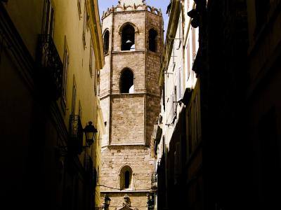 The bell tower of Alghero Cathedral above the old-town lanes