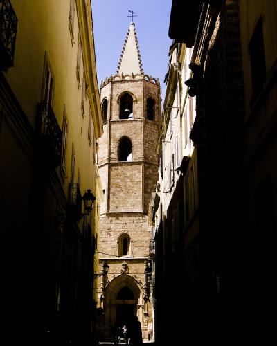 The bell tower of Alghero Cathedral above the old-town lanes
