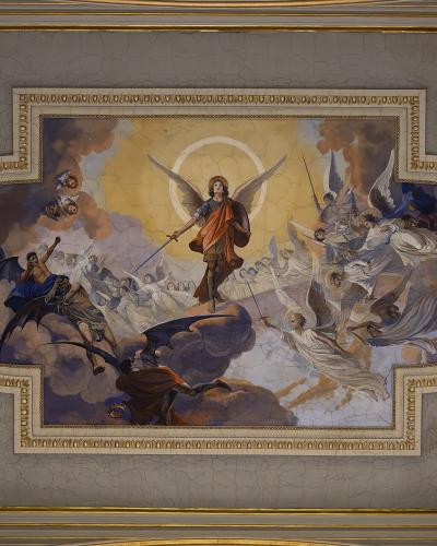 A ceiling fresco depicting the Archangel Michael triumphing over demons, signed by Luigi Taglialatela and dated 1944, framed with ornate plasterwork.