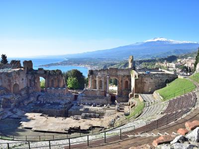 The ancient Greek theatre of Taormina with Mount Etna and the Sicilian coast beyond