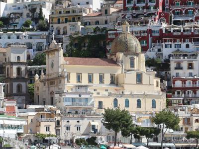 Positano climbing the cliffs around the majolica dome of Santa Maria Assunta