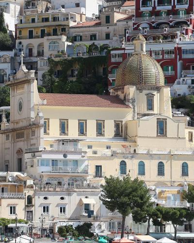 Positano climbing the cliffs around the majolica dome of Santa Maria Assunta