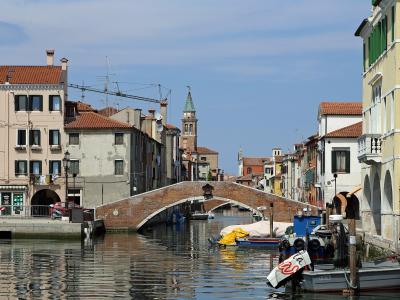Boats and a stone bridge on the Canal Vena in Chioggia, beside the fish market